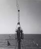 LV-112 -  View from the top of the aft mast to the forward mast. Enginemen were replacing navigational lights. The anemometer is halfway out on the yardarm on the left. Photos taken by crewman, Rich Racicot, 1964-66.