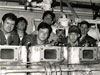 Vocational school students participating in repairs, during an instructional class on LV-112's 8-cylinder, 900hp Cooper-Bessemer diesel main engine. Three of the cylinder heads are shown in the foreground. (Photo courtesy of Don Yeskoo)